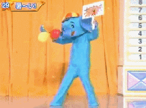 an old gif of a Kesoh Taishou costume performance; a man in a blue elephant mascot walks in, drops his balloons and his sign, and takes off the mascot suit onstage; still too hot, he loosens up, sits on his mascot suit head, and collapses; a small girl climbs out through the man's shirt like she was wearing him as a suit, and she greets the audience