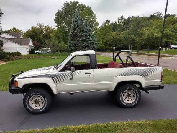 first-generation Toyota 4Runner, a real SUV, shown with the top removed so that it looks like a pickup truck with a seat in the cargo bed