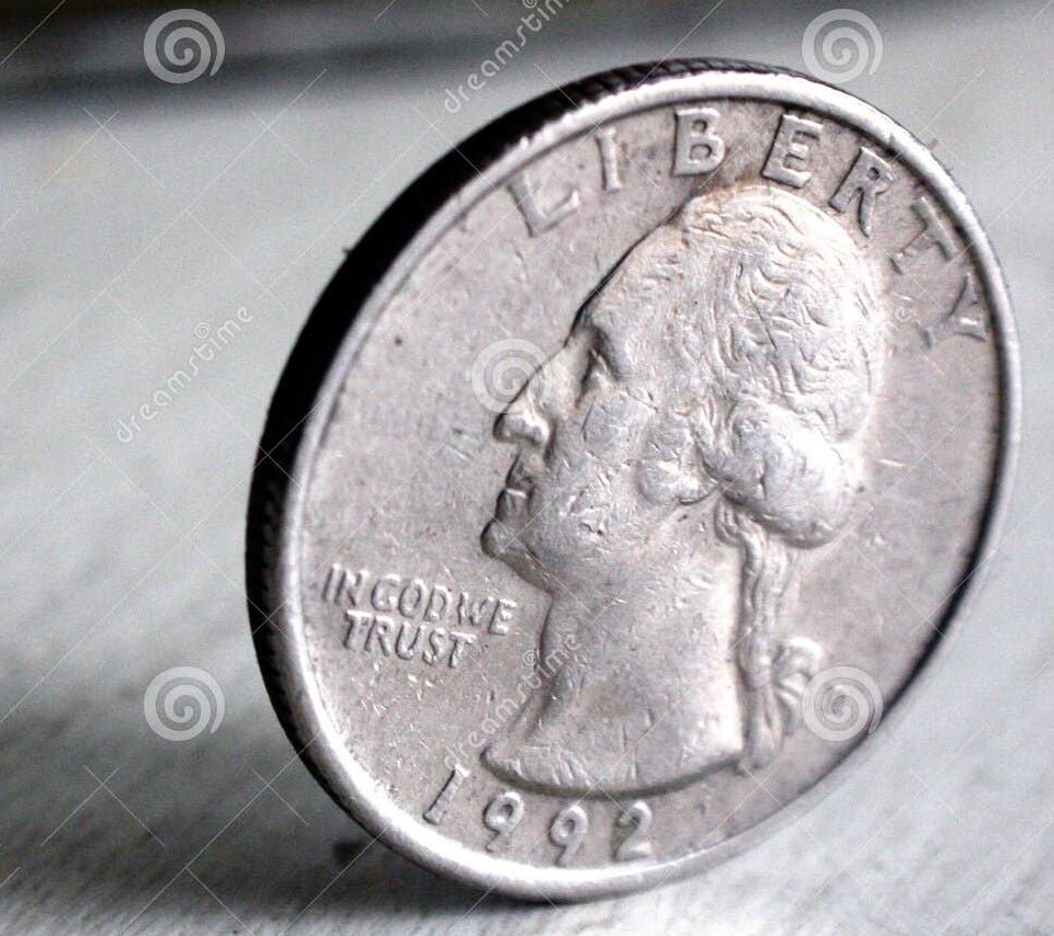 A quarter balanced perfectly on its edge