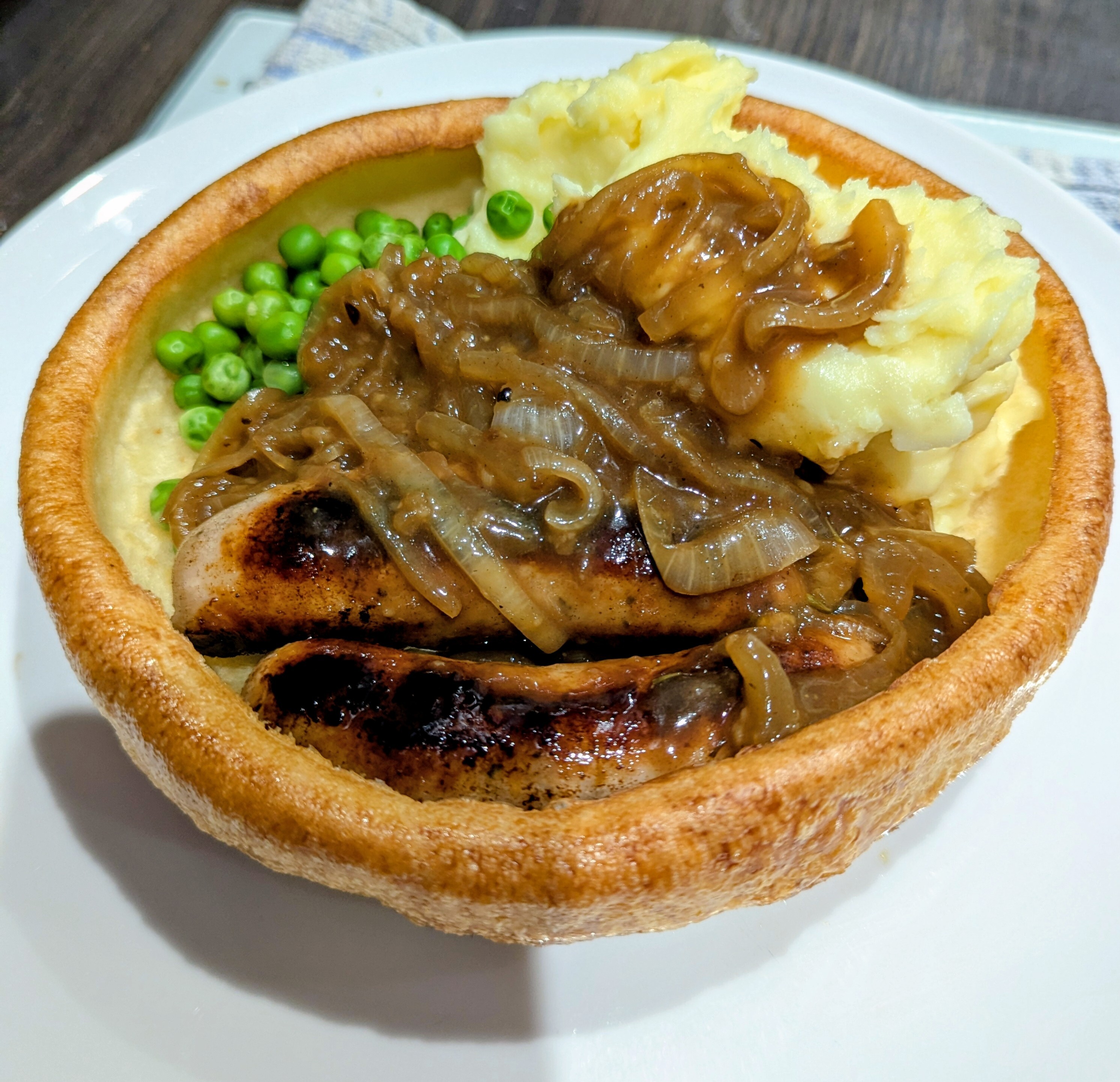 Bangers and mash in a large Yorkshire pud